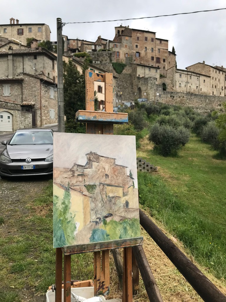 Is a photograph of the painting in progress after two hours. The panel stands on an easel with the subject matter in the background. You can see the artist's colours. The initial painting is very thin and the painting is broad and loose.